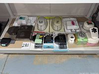 Shelf view showing all fifteen paper punches arranged in two rows