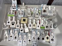 Overview of roughly 35 Martha Stewart paper punches arranged on table