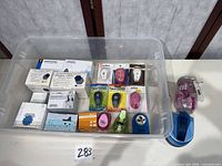 Overview of entire lot in clear tote showing boxed Creative Memories punches, jar of mini punches and assorted loose punches