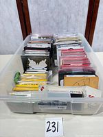 Top view of clear bin holding approximately 35 die cases and packs