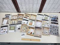 All 22 sealed die and stamp sets laid out