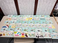 Full layout of approximately 30 Slice design card packs on table