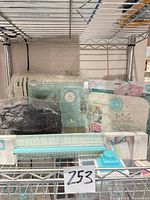 Lot overview showing sewing machine, punch board, trimmer and accessories on shelving