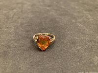 Front view of 10kt gold ring showing orange sapphire