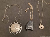 Overview of all three Haida pendant necklaces