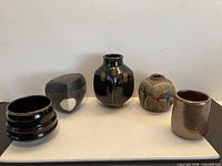 All five pottery pieces side by side