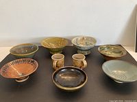 All nine pottery pieces arranged together