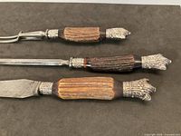 Full view of knife, fork and steel showing stag handles and silver mounts