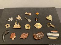 Full layout of all 17 brooches on black background