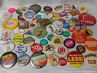 Overall view of approx. 55 assorted pin-back buttons