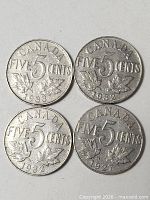 Four Canadian 5 cent coins reverse side showing dates 1933, 1932, 1932, 1927