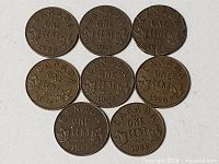 Eight Canadian one cent coins reverse side showing dates
