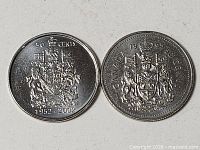 Both 50-cent coins reverse sides showing Canadian Coat of Arms
