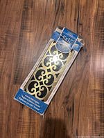 Packaged brass-tone Victorian style 4x12 floor vent register