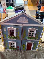 front view showing blue brick facade with windows and door