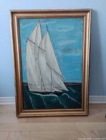 Front view of sailboat oil painting showing vessel, sea and gold frame