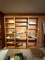 Three IKEA Billy bookcases side by side showing shelves