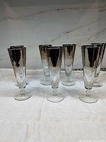 Seven silver fade pilsner glasses front view