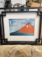 Framed Mount Fuji print with mat and black geometric frame visible