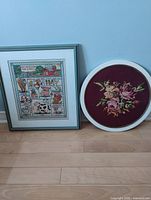 Front view of both framed needleworks showing designs and frames