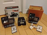 Overall lot showing two GAF Pana-vue Automatic slide viewers with accessories and one Kodak Kodaslide Stereo Viewer