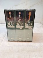 Front view showing three VHS spines in sealed shrink-wrap