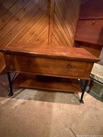 Front view of wood media console showing drawer and shelf