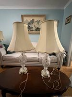 Both cut glass lamps with shades on table