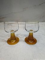 Two vintage German amber stem Roemer wine glasses side by side