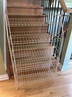 Front view of white five-tier wire shoe rack