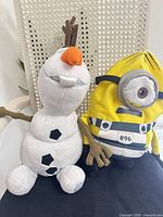 Front view of Olaf and Minion plush toys