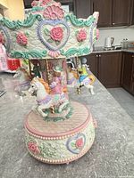 Overall view of carousel music box showing horses and decorative crown