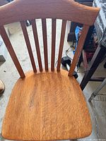 Front view of oak mission dining chair showing seat and slat back