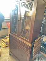 Full view of china cabinet showing glass doors and lower storage