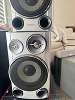 Front view of stacked speakers showing drivers, ports, and Sony branding