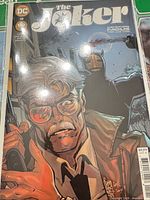 Front cover of The Joker #12 comic in bag and board