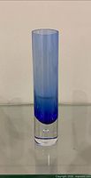 Full view of cylindrical blue cased glass vase