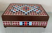 full view of closed wooden music box showing mosaic tile lid pattern