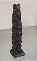 Totem pole side view showing owl top and carved details