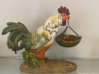 Left side view of rooster warmer with hanging dish