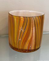 Front view showing multicoloured swirl pattern and cylindrical shape