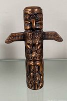 Full view of copper totem pole piggy bank front