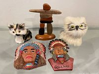 front view showing all five items: inukshuk, owl, kitten, two magnets
