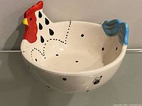 Side view showing rooster head, tail and interior pattern