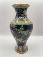 Full frontal view of cloisonné vase showing floral decoration and shape