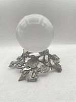 Full view of crystal ball on pewter stand