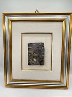 Full view of framed cityscape relief art