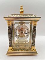 Front view of ornate brass enamel mantel clock