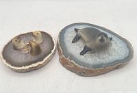 Both sculptures side by side showing overall form and materials