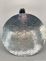 Top view showing engraved sun design and hammered surface